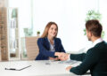 Human resources manager shaking hands with applicant